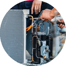 HVAC technician repairing a cooling system, showcasing expert maintenance services for reliable heating and cooling solutions.