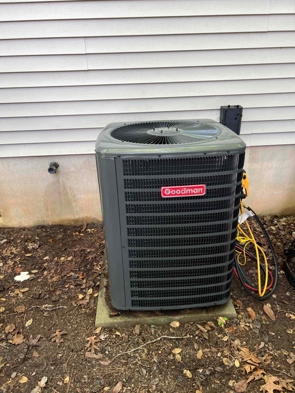 Goodman air conditioning unit installed outside a home, showcasing efficient cooling system setup for residential HVAC needs.